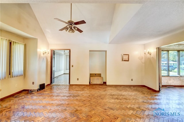 spare room featuring ceiling fan, a textured ceiling, high vaulted ceiling, and light parquet floors