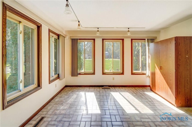 9740 Maumee Western Rd, Monclova, OH 43542 - spare room featuring plenty of natural light, brick floor, and track lighting