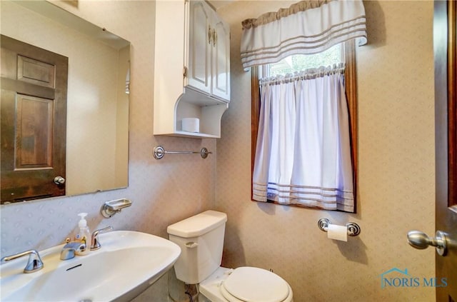 9740 Maumee Western Rd, Monclova, OH 43542 - bathroom featuring toilet, wallpapered walls, and a sink