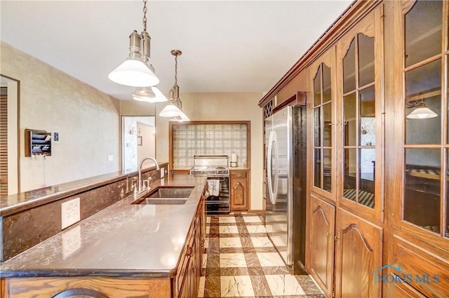 9740 Maumee Western Rd, Monclova, OH 43542 - kitchen featuring freestanding refrigerator, glass insert cabinets, gas stove, a sink, and brown cabinets