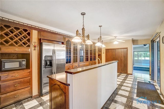 9740 Maumee Western Rd, Monclova, OH 43542 - kitchen featuring a ceiling fan, marble finish floor, a kitchen island with sink, hanging light fixtures, and stainless steel appliances