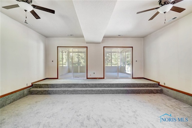 empty room with ceiling fan and carpet flooring