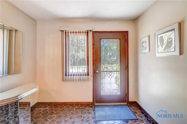 9740 Maumee Western Rd, Monclova, OH 43542 - doorway with dark tile patterned flooring and baseboards