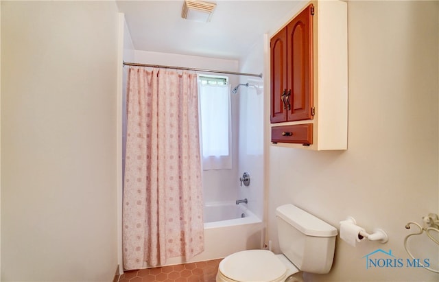 bathroom featuring shower / bath combo and toilet