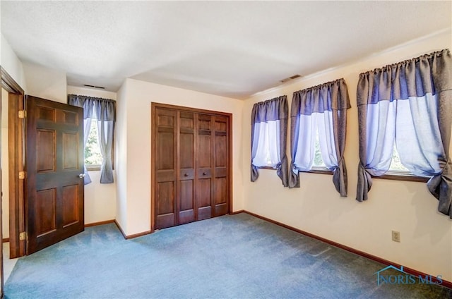 9740 Maumee Western Rd, Monclova, OH 43542 - unfurnished bedroom featuring carpet, visible vents, a closet, and baseboards