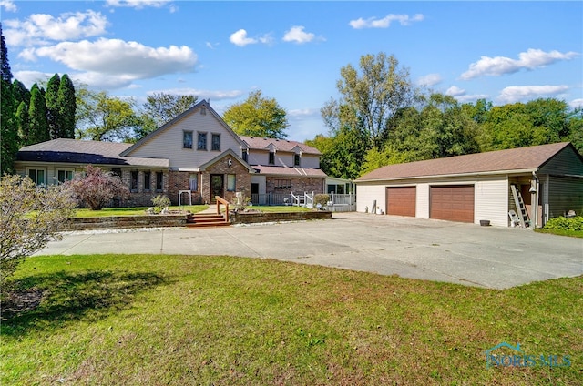 view of front of home with a front lawn, an outdoor structure, a porch, and a garage