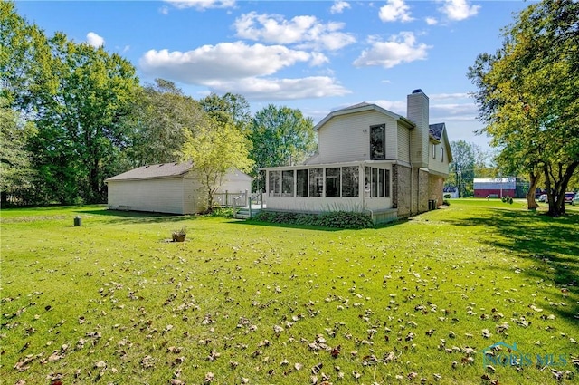 9740 Maumee Western Rd, Monclova, OH 43542 - back of property featuring a sunroom, a yard, an outdoor structure, and a chimney