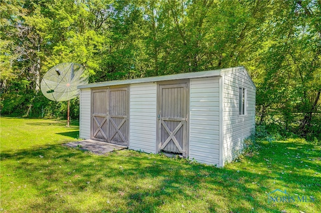 view of outbuilding featuring a lawn