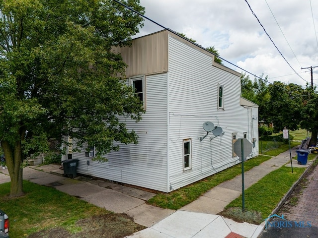 view of side of home featuring a yard