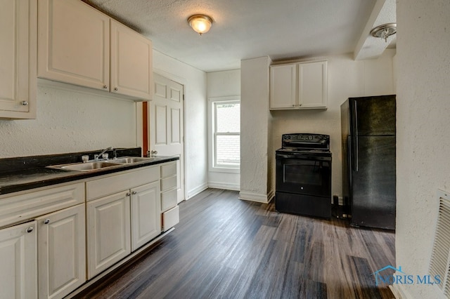 kitchen with a textured ceiling, dark hardwood / wood-style floors, sink, white cabinetry, and black appliances