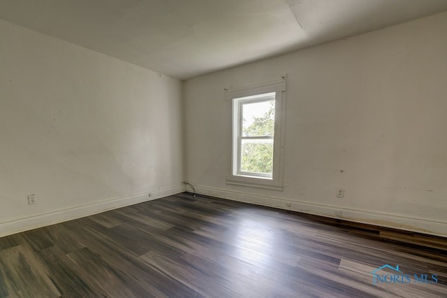 spare room with dark hardwood / wood-style flooring