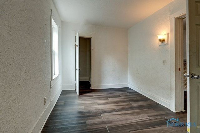 spare room with dark hardwood / wood-style flooring