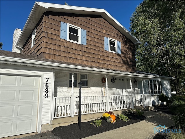 view of front facade featuring a garage and covered porch