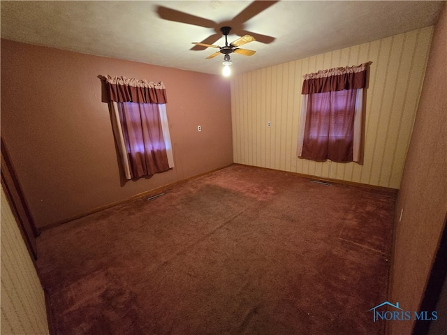 carpeted spare room with ceiling fan