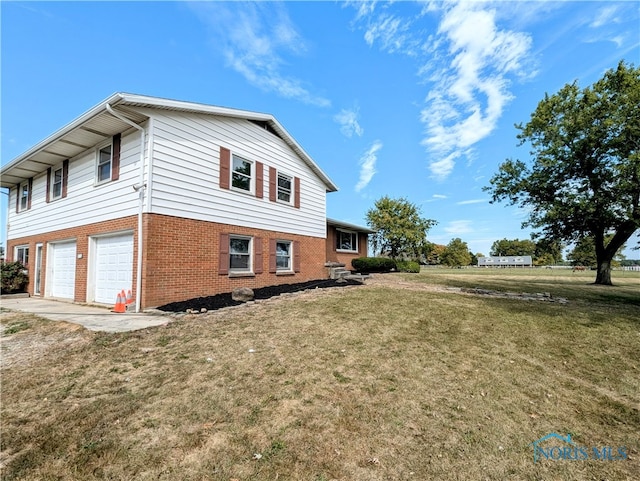 view of home's exterior with a garage and a lawn