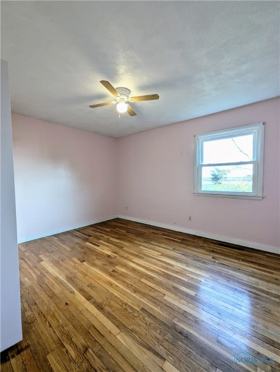 empty room featuring wood-type flooring and ceiling fan