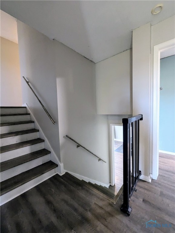 stairway featuring hardwood / wood-style flooring