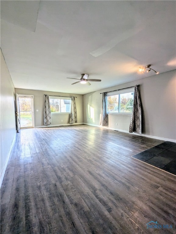 spare room featuring dark hardwood / wood-style flooring and plenty of natural light