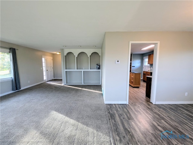 unfurnished living room featuring dark hardwood / wood-style flooring