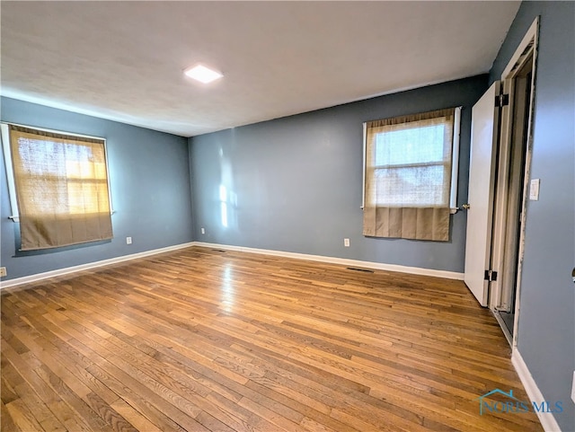 unfurnished room featuring hardwood / wood-style floors