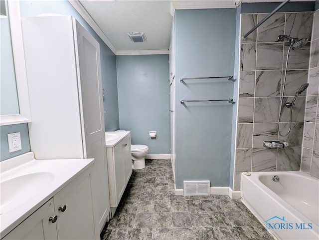 full bathroom featuring vanity, tiled shower / bath, toilet, and crown molding