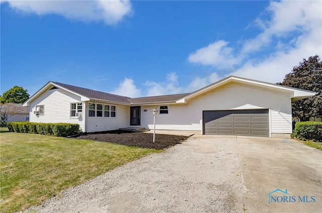 ranch-style house featuring a garage and a front lawn