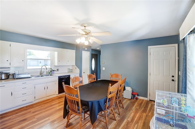 dining space featuring ceiling fan, sink, and light hardwood / wood-style floors