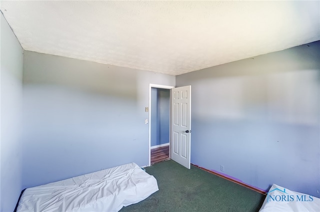 carpeted bedroom with a textured ceiling