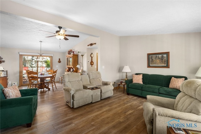 living room with a textured ceiling, dark wood-type flooring, ceiling fan, and vaulted ceiling with beams