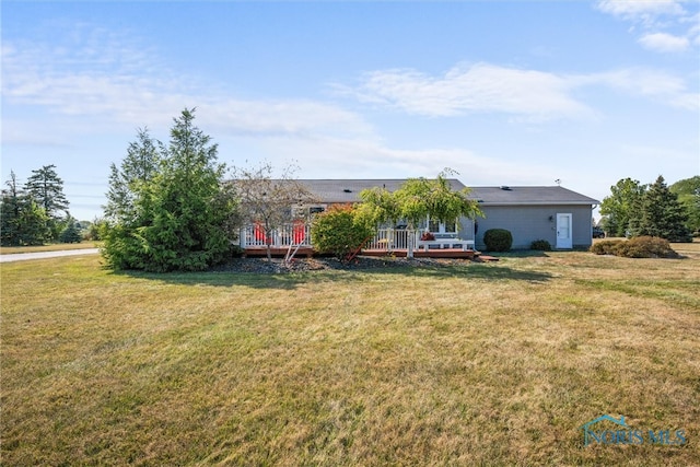 ranch-style house with a front yard and a wooden deck