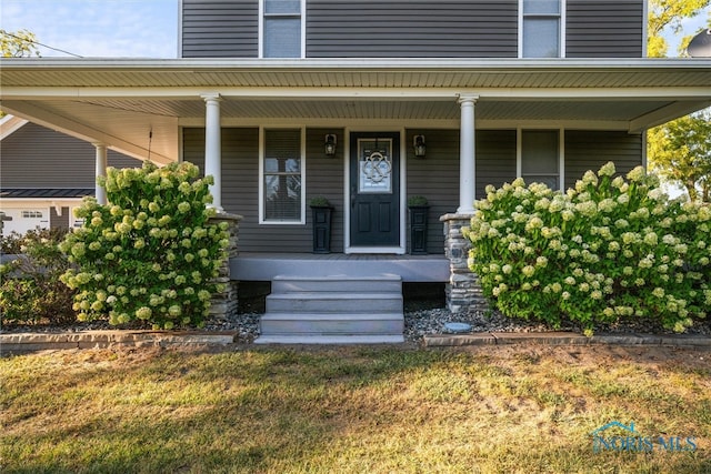 view of exterior entry with covered porch