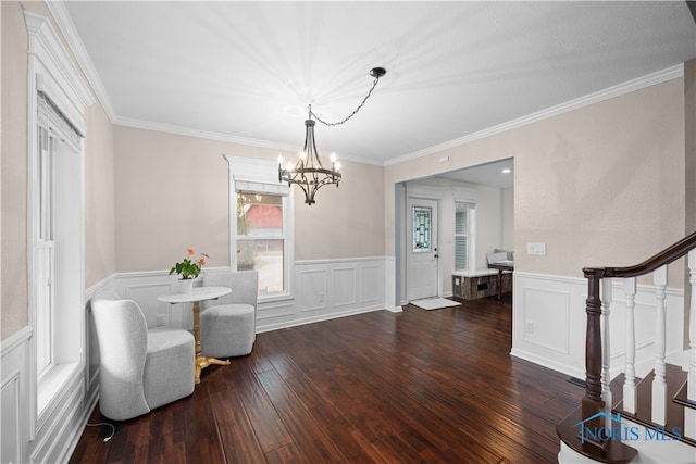 interior space featuring a notable chandelier, crown molding, and dark hardwood / wood-style flooring