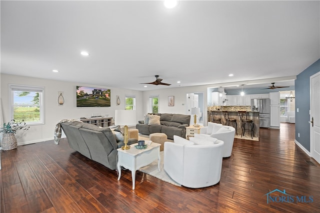 living room with ceiling fan and dark hardwood / wood-style floors