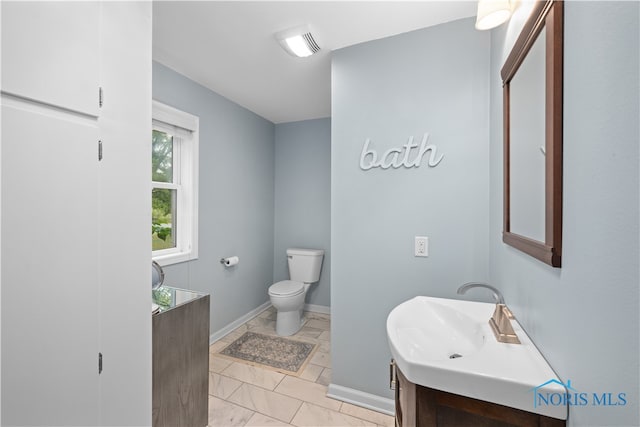 bathroom featuring vanity and toilet