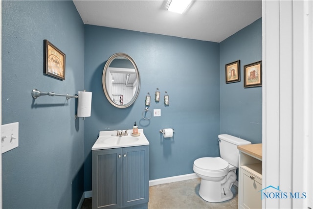 bathroom featuring a textured ceiling, vanity, and toilet