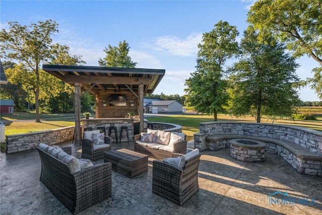 view of patio with a gazebo and an outdoor living space with a fireplace