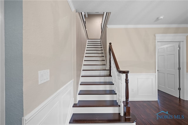 staircase featuring ornamental molding and hardwood / wood-style flooring