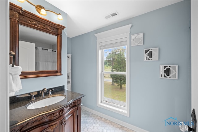 bathroom with tile patterned floors, a shower with curtain, and vanity