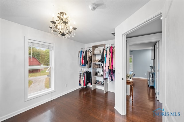 interior space featuring dark hardwood / wood-style flooring and a chandelier