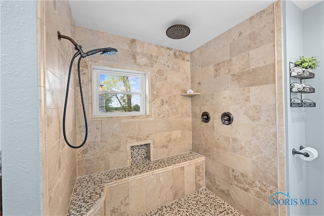 bathroom with a tile shower