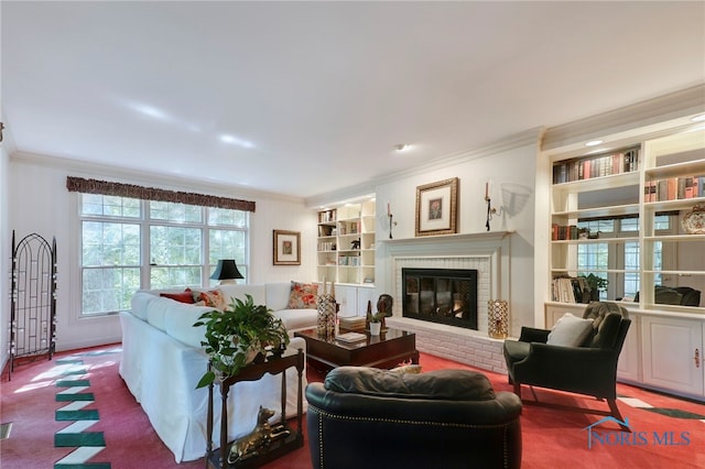 living room with a brick fireplace, carpet floors, crown molding, and built in features