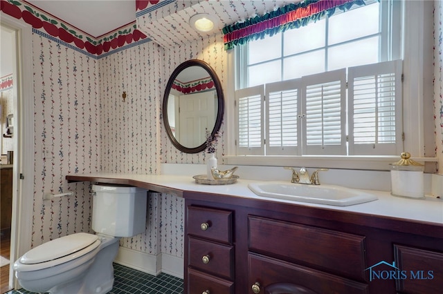 bathroom featuring vanity, toilet, and tile patterned floors