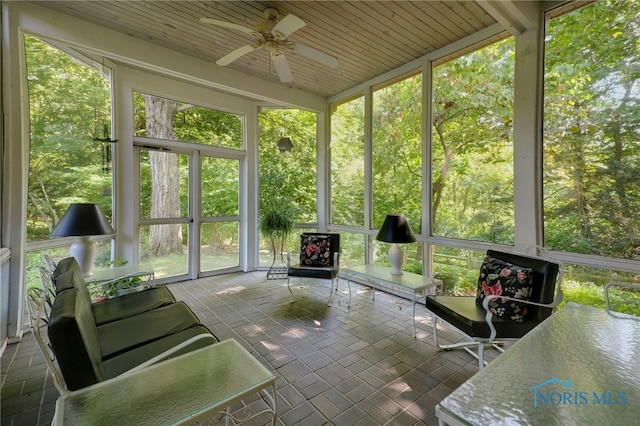 unfurnished sunroom with ceiling fan and wooden ceiling