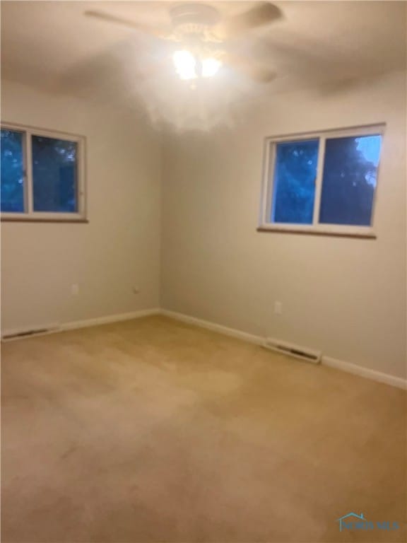 carpeted empty room with ceiling fan