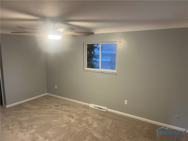 carpeted spare room with ceiling fan