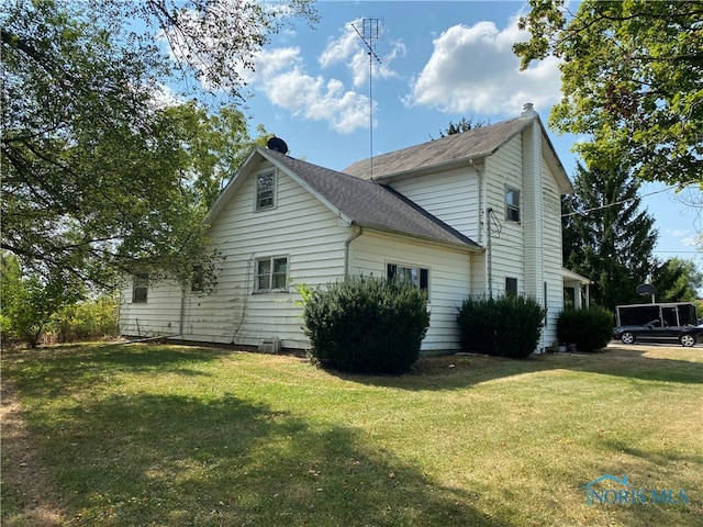 view of property exterior featuring a lawn