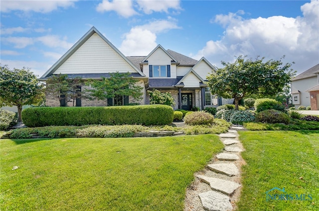 craftsman-style home featuring a front lawn