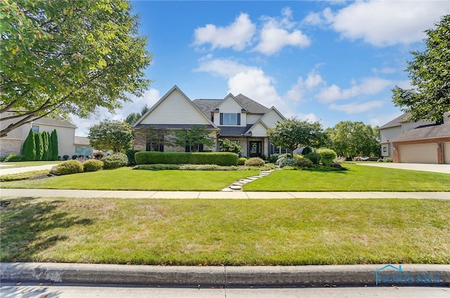 tudor home featuring a garage and a front lawn