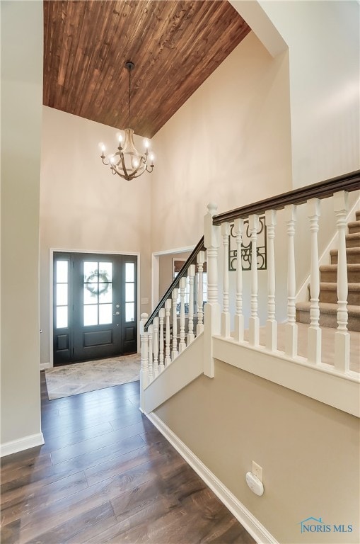 entrance foyer featuring wood ceiling, wood-type flooring, high vaulted ceiling, and a chandelier