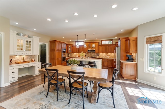 dining room featuring a wealth of natural light and light hardwood / wood-style flooring